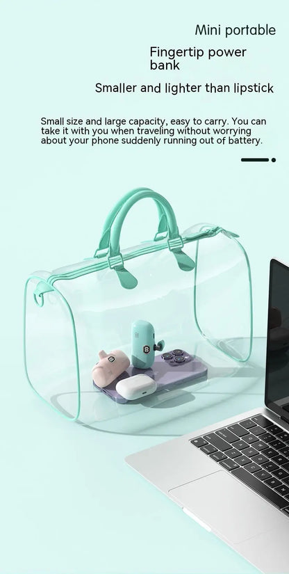 Mini portable power bank in a transparent bag next to a laptop, featuring fingertip design, and smaller than a lipstick for easy travel.