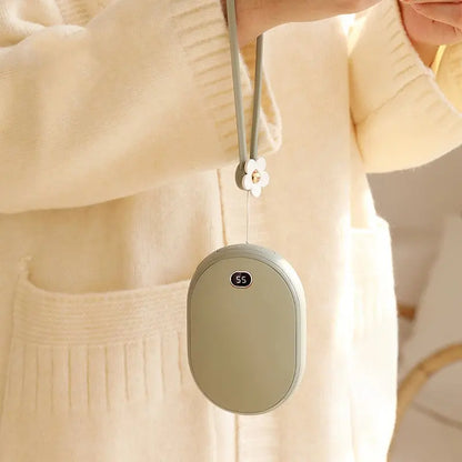 Compact mini power bank with digital display hanging from a lanyard, worn by a person in a beige sweater.